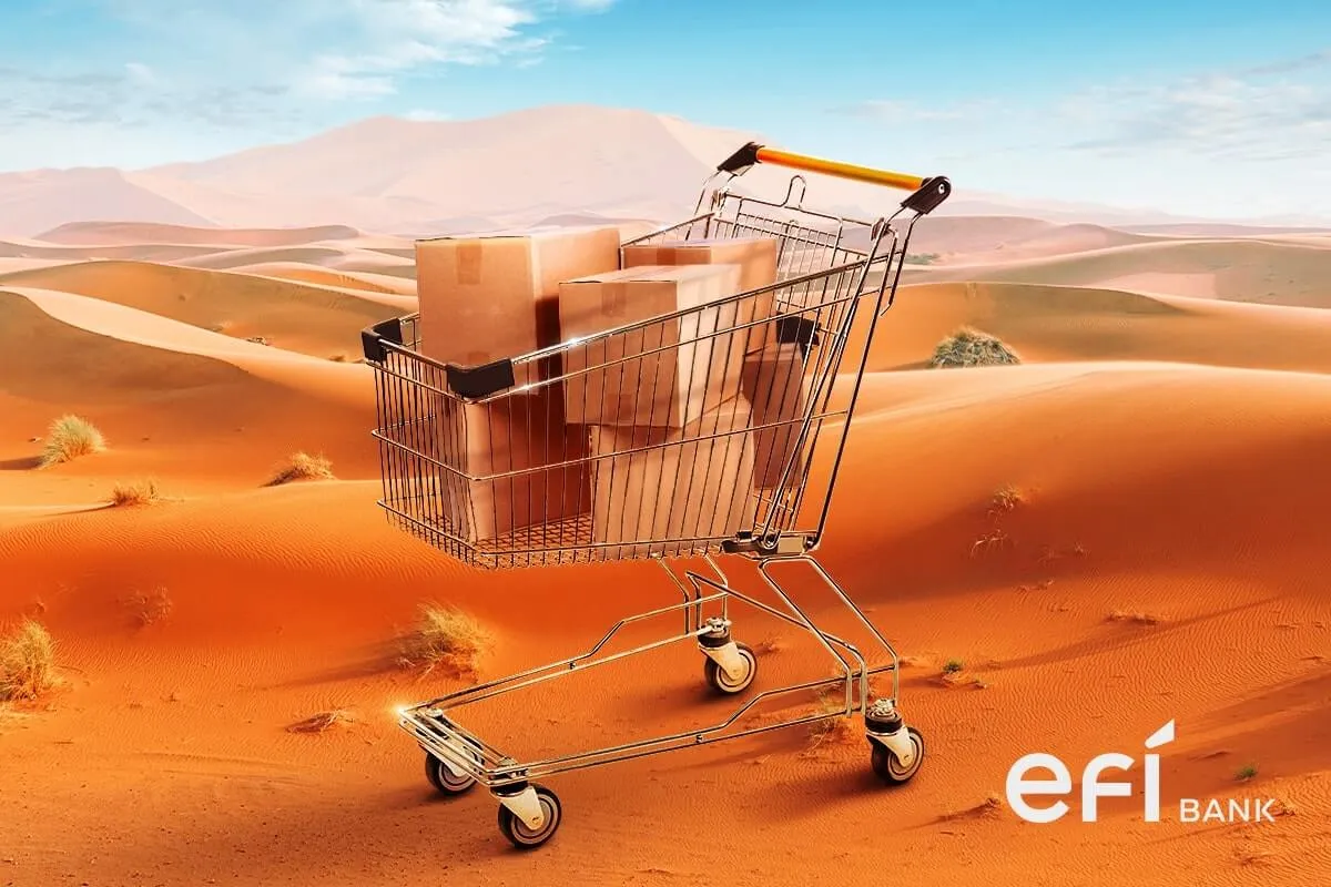 Carrinho de supermercado com caixas de papelão dentro em cenário desertico